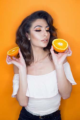 citrus fruit woman holding sliced orange fruit